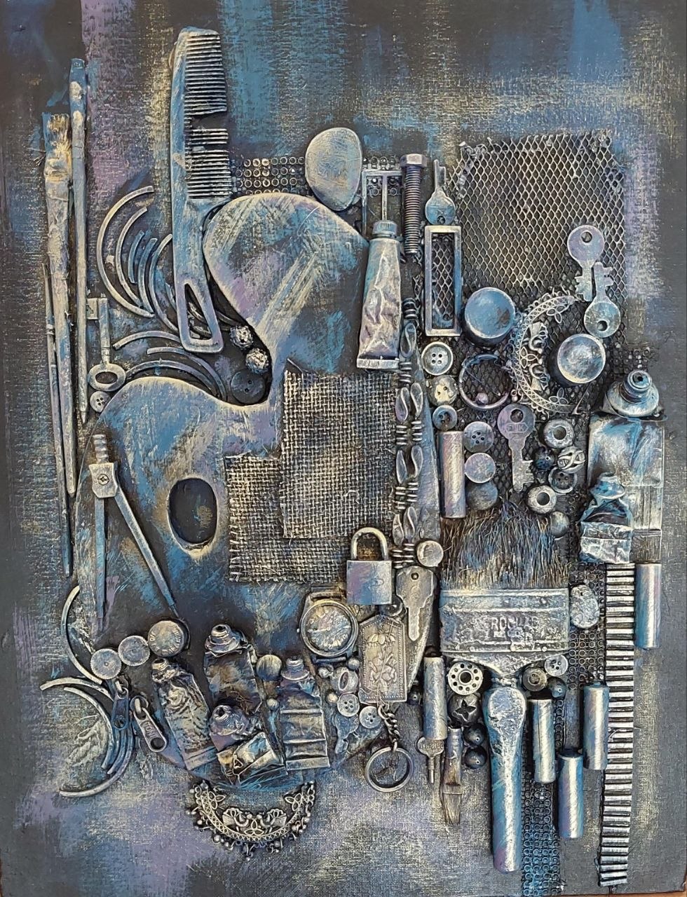 Mixed media assemblage canvas painted in metallic blue and silver with combs, locks, scissors and paint tubes