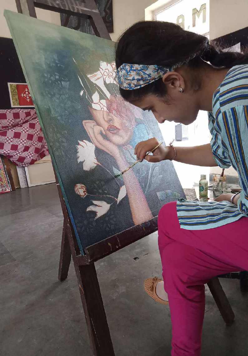 Karuna Manocha working on an canvas easel