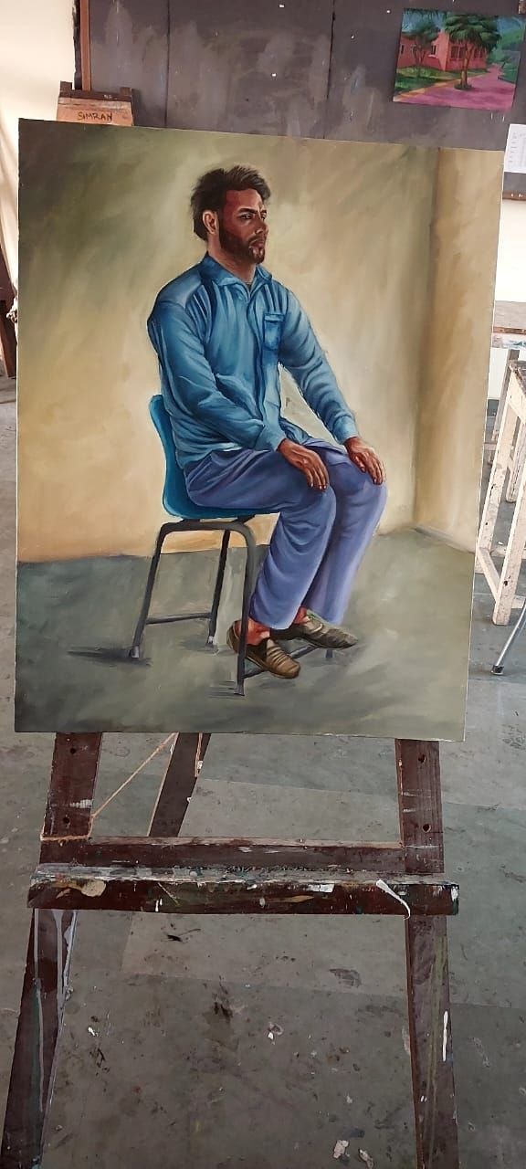 Live study oil painting of a sitting man wearing a blue outfit in quiet reflection